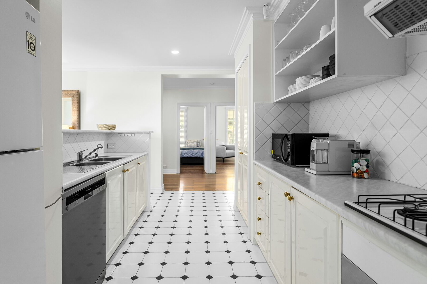 Close-up of a kitchen countertop with a sink and new cabinetry.